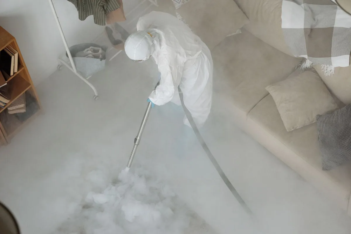 Biohazard cleanup technician in protective equipment, Lesage, WV
